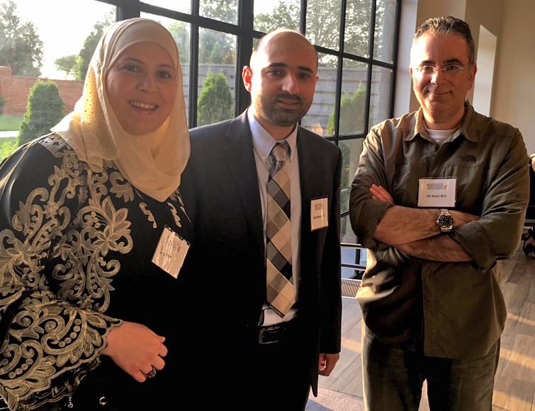 Female and male resident with faculty member