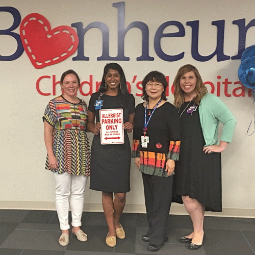 Fellows and program director before a Le Bonheur banner