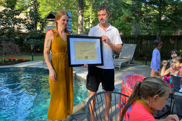 fellows at graduation outdoor by a pool