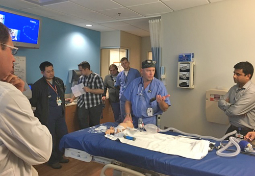 Faculty and fellows in a hospital room