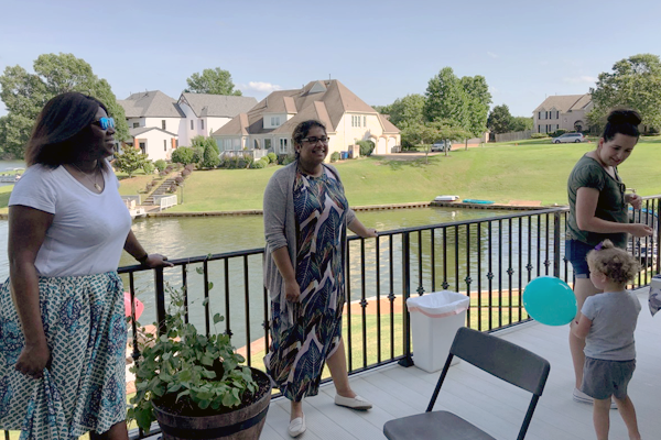 Residents at an outdoor patio by a lake