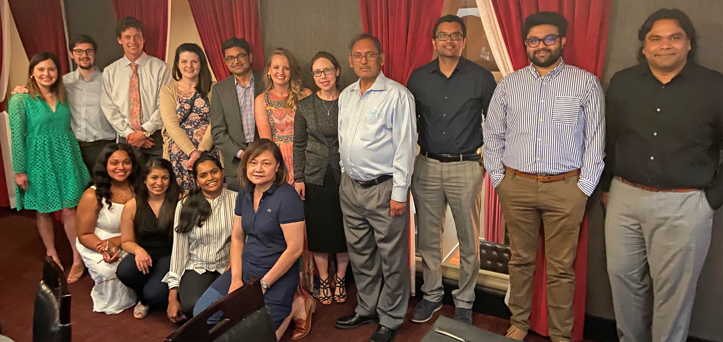 Group photo of fellows at a party inside