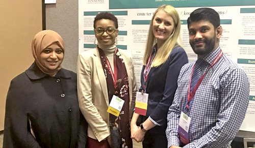 Fellows in front of a poster presentation