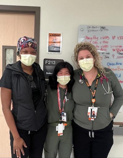 Three female fellows in the hallway