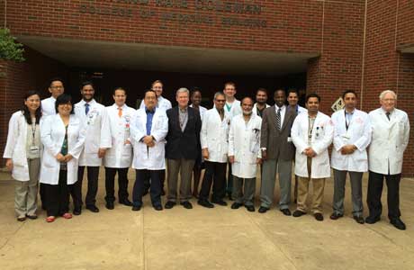 Faculty and fellows outside the Coleman Building