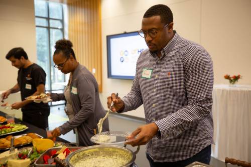 a man getting food at the YPG mixer